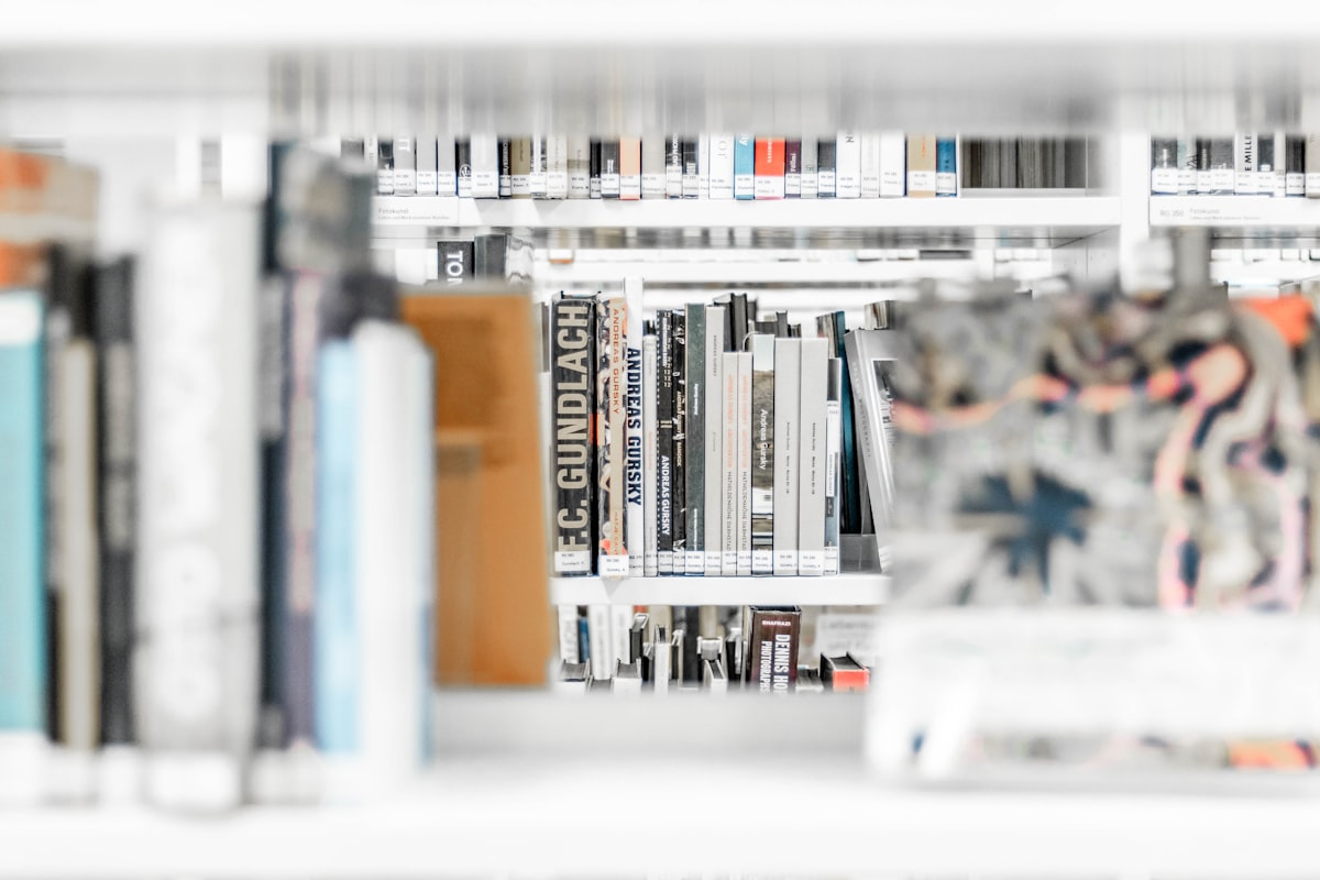 Assorted books on wooden bookshelves in a library