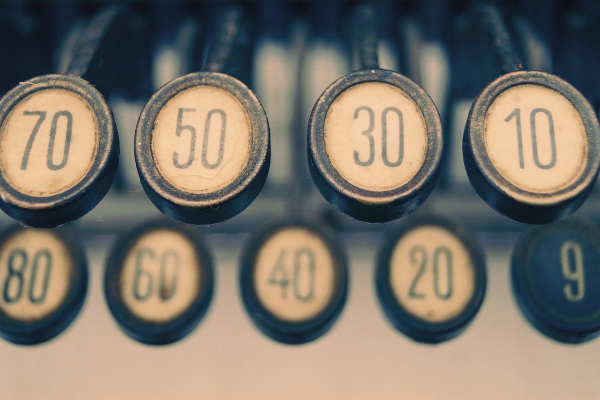 Close-up of vintage typewriter number keys, representing how numerals and abbreviations behave differently from ordinary words in title case